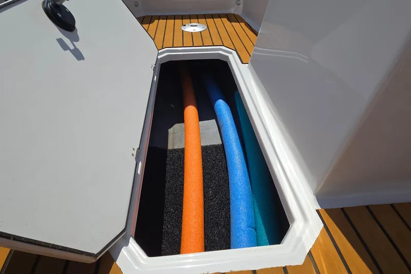 Slide: The Image of Storage compartment on 2021 Starcraft SVX 191 OB boat with colorful pool noodles. - 39