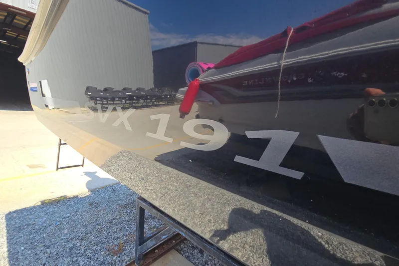 Slide: The Image of 2021 Starcraft SVX 191 OB boat exterior with reflective surface and model number. - 7