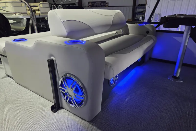Slide: The Image of 2026 Avalon Platinum LSZ 2385 Entertainer boat interior with illuminated seating and cup holders. - 14