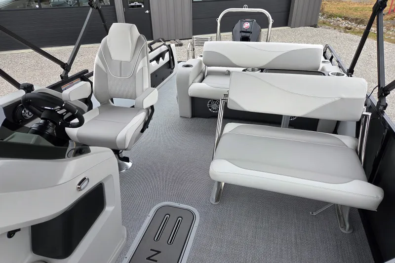 Slide: The Image of 2026 Avalon Platinum LSZ 2385 Entertainer boat interior with modern seating and steering console. - 5