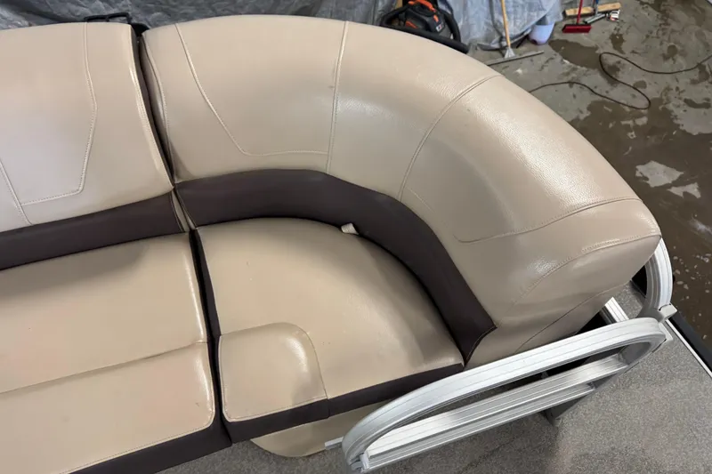 Slide: The Image of 2018 Sun Tracker SportFish 22 XP3 boat seating, beige and brown upholstery, close-up view. - 10