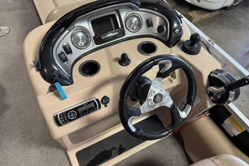 Slide: The Image of 2018 Sun Tracker SportFish 22 XP3 dashboard with steering wheel and control panel. - 15