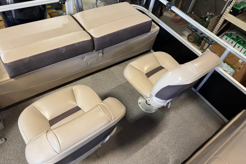Slide: The Image of 2018 Sun Tracker SportFish 22 XP3 interior with beige seating and carpeted floor. - 17