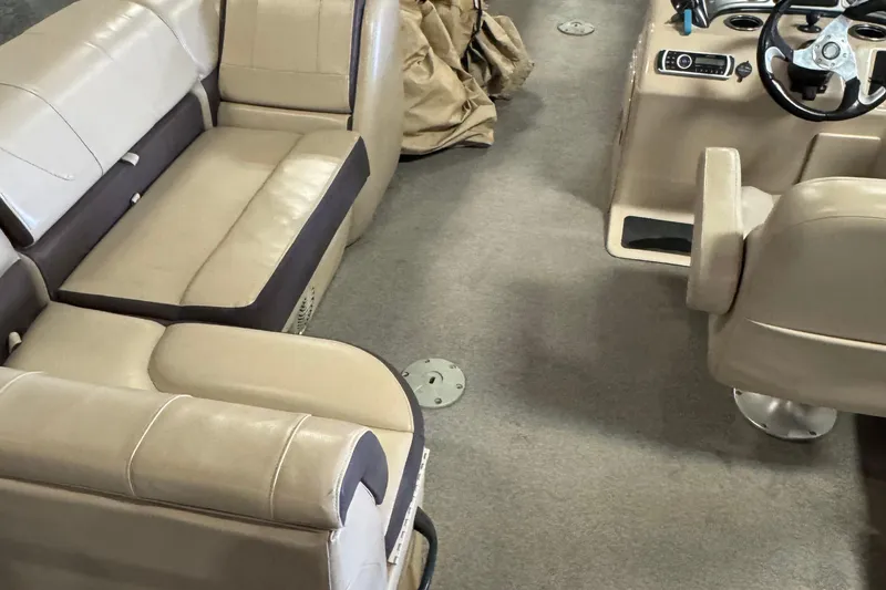 Slide: The Image of Interior of 2018 Sun Tracker SportFish 22 XP3 with beige seating and steering console. - 20