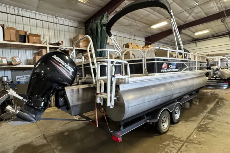 Slide: The Image of 2018 Sun Tracker SportFish 22 XP3 pontoon boat with Mercury outboard motor in a storage facility. - 4