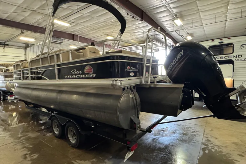 Slide: The Image of 2018 Sun Tracker SportFish 22 XP3 pontoon boat with Mercury outboard engine in a warehouse. - 6
