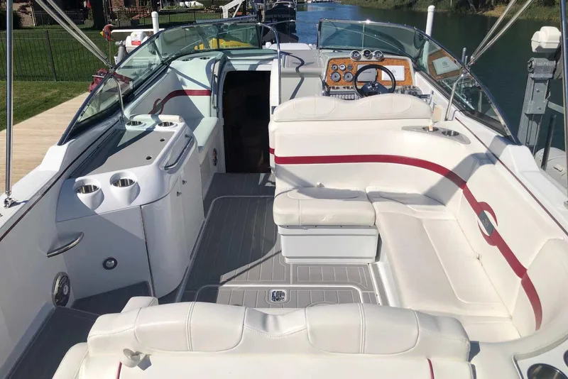 Slide: The Image of 2012 Formula 310 Sun Sport boat interior with white seating and red accents. - 13