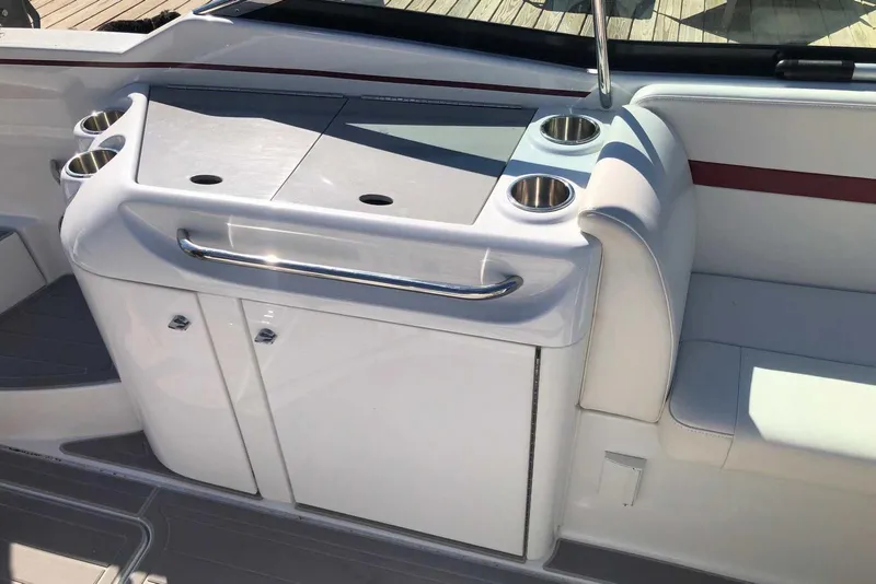 Slide: The Image of 2012 Formula 310 Sun Sport boat interior with cup holders and storage. - 15