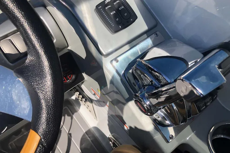 Slide: The Image of 2012 Formula 310 Sun Sport boat dashboard with steering wheel and controls. - 22