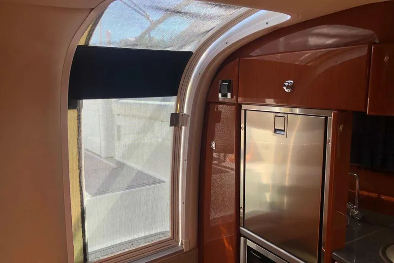 Slide: The Image of Interior of 2012 Formula 310 Sun Sport with stainless steel fridge and curved window. - 30