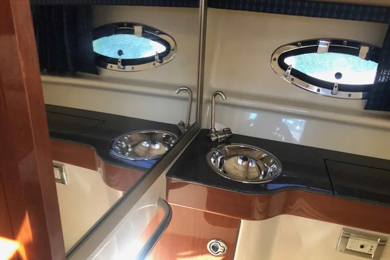 Slide: The Image of Interior of 2012 Formula 310 Sun Sport boat featuring a sleek sink and porthole window. - 34