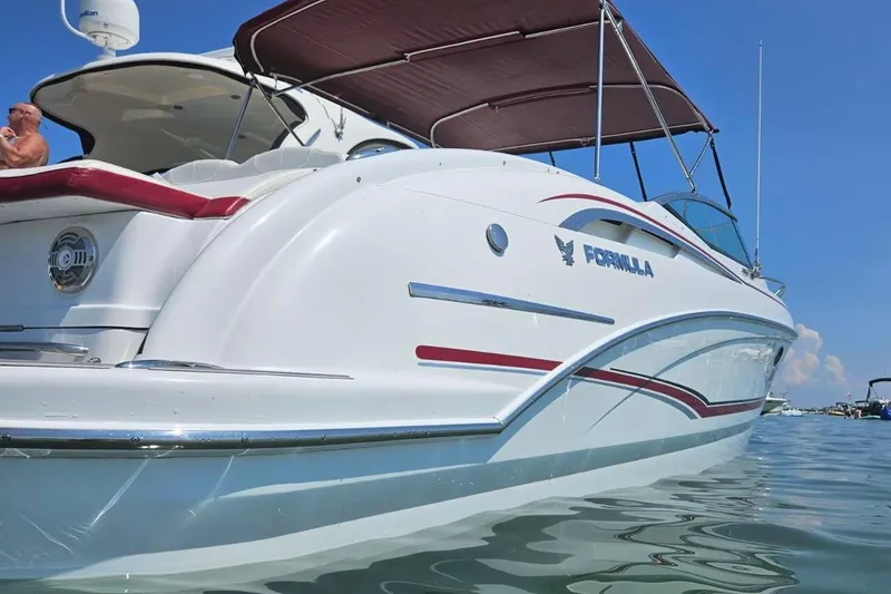 Slide: The Image of 2012 Formula 310 Sun Sport boat on water, featuring sleek design and canopy. - 39