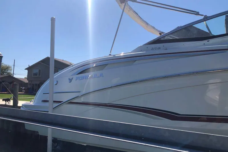 Slide: The Image of 2012 Formula 310 Sun Sport boat docked under clear blue sky. - 9