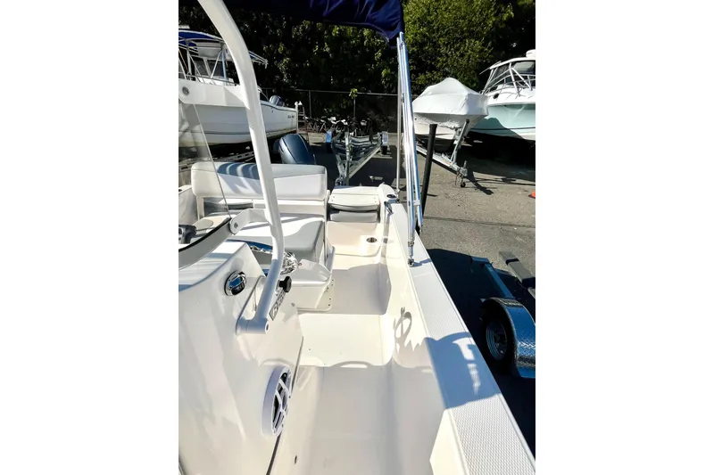 Slide: The Image of 2021 Robalo R160 Center Console boat interior with seating and console view. - 11