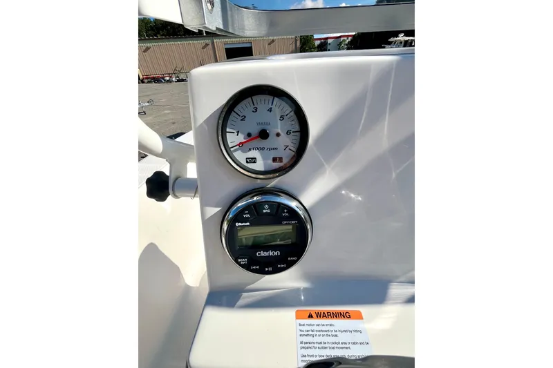 Slide: The Image of 2021 Robalo R160 Center Console dashboard with Yamaha tachometer and Clarion audio system. - 15