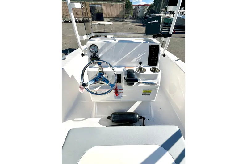 Slide: The Image of 2021 Robalo R160 Center Console boat interior with steering wheel and controls. - 16