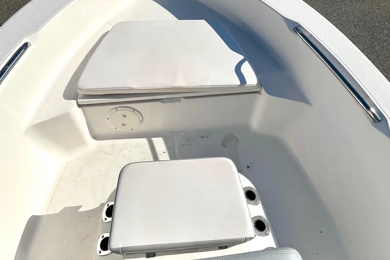 Slide: The Image of 2021 Robalo R160 Center Console boat interior with cushioned seating and storage. - 8