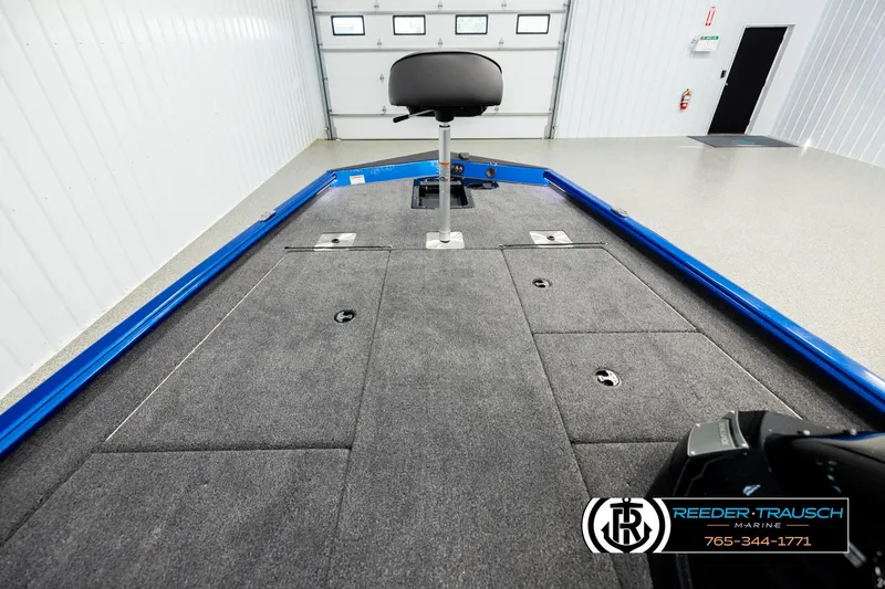 Slide: The Image of 2026 Lund 1875 Renegade boat interior with carpeted deck and seating. - 13