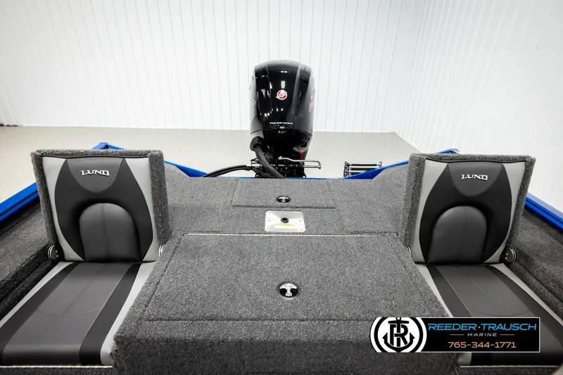 Slide: The Image of 2026 Lund 1875 Renegade boat interior with seating and motor, displayed at Reeder-Trausch Marine. - 16