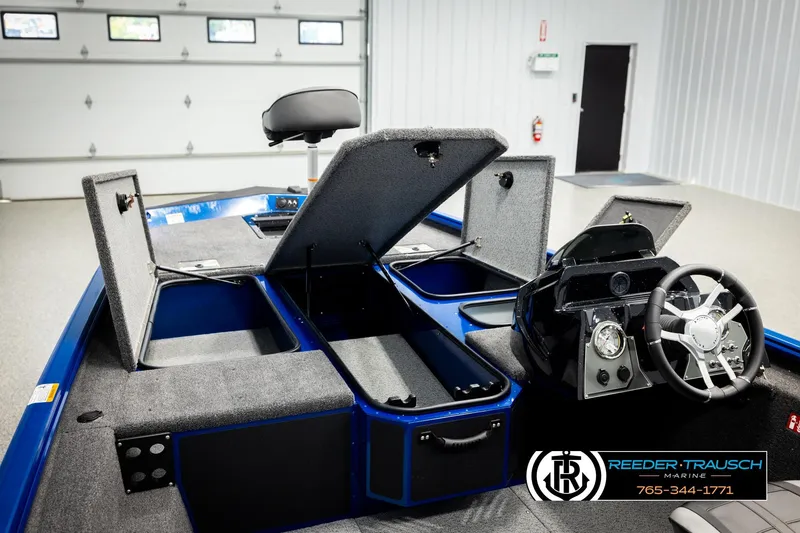 Slide: The Image of 2026 Lund 1875 Renegade boat interior with open storage compartments and steering console. - 22