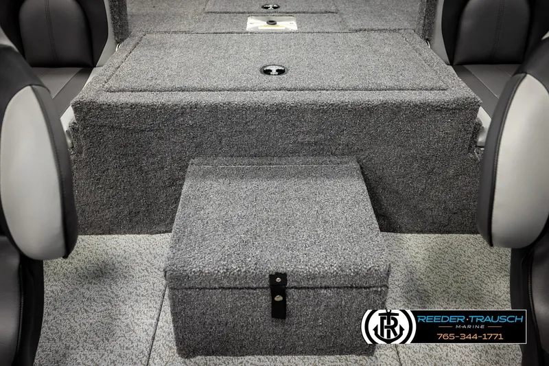 Slide: The Image of 2026 Lund 1875 Renegade boat interior with gray carpeted storage compartments. - 23
