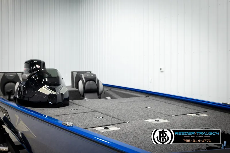 Slide: The Image of 2026 Lund 1875 Renegade boat in showroom, featuring sleek design and modern seating. - 25