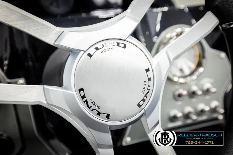 Slide: The Image of Steering wheel of 2026 Lund 1875 Renegade boat, featuring sleek design and branding. - 29