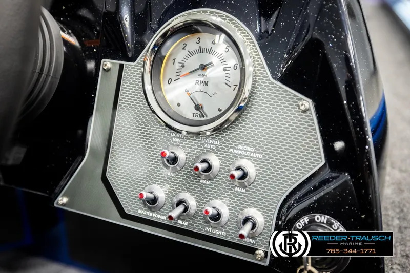 Slide: The Image of Control panel of 2026 Lund 1875 Renegade boat with RPM gauge and switches. - 31