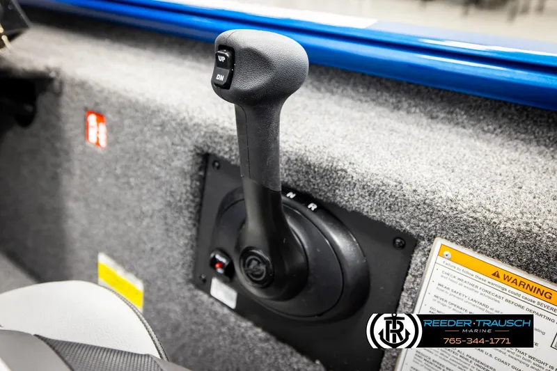 Slide: The Image of 2026 Lund 1875 Renegade boat throttle control with warning label and dealership logo. - 32