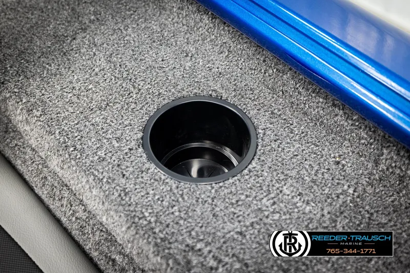 Slide: The Image of 2026 Lund 1875 Renegade boat interior with cup holder and carpeted surface. - 38