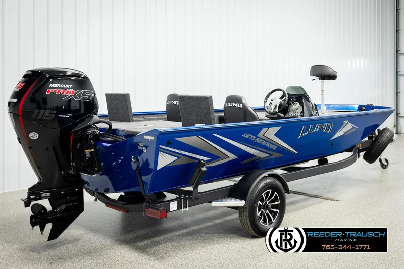 Slide: The Image of 2026 Lund 1875 Renegade boat with Mercury Pro XS engine, displayed indoors. - 4