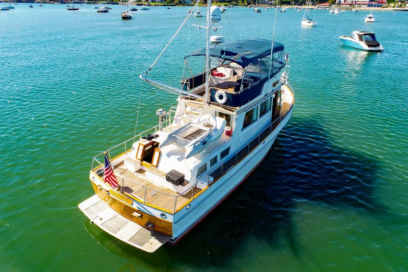 Slide: The Image of Grand Banks 42 Classic 1988 yacht on serene water with other boats nearby. - 1