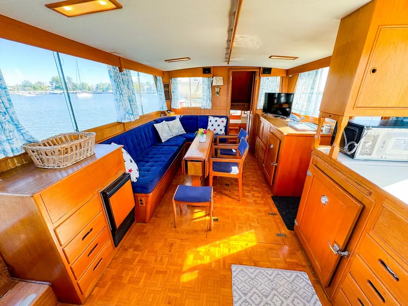 Slide: The Image of Interior of 1988 Grand Banks 42 Classic yacht with wood finish and blue seating. - 13
