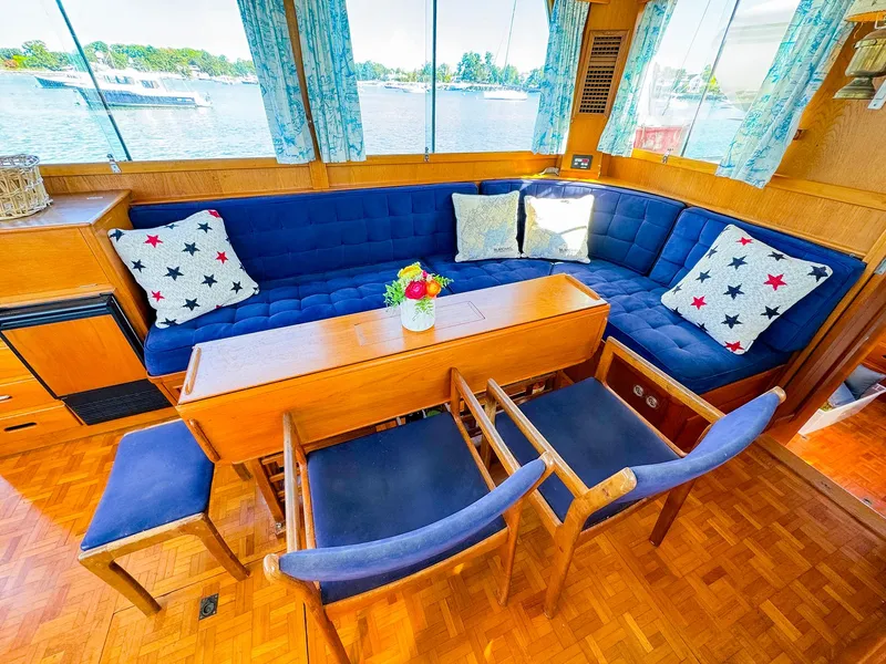 Slide: The Image of Interior of 1988 Grand Banks 42 Classic yacht with blue seating and wooden table. - 16