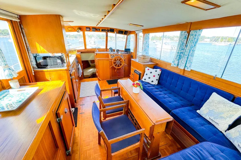 Slide: The Image of Interior of 1988 Grand Banks 42 Classic yacht with blue seating and wooden accents. - 17