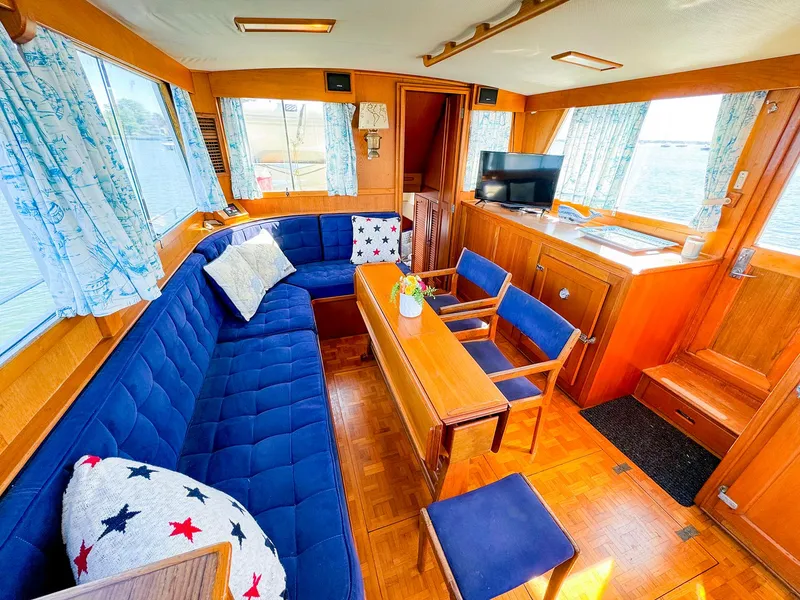 Slide: The Image of Interior of 1988 Grand Banks 42 Classic yacht with blue seating and wooden accents. - 18