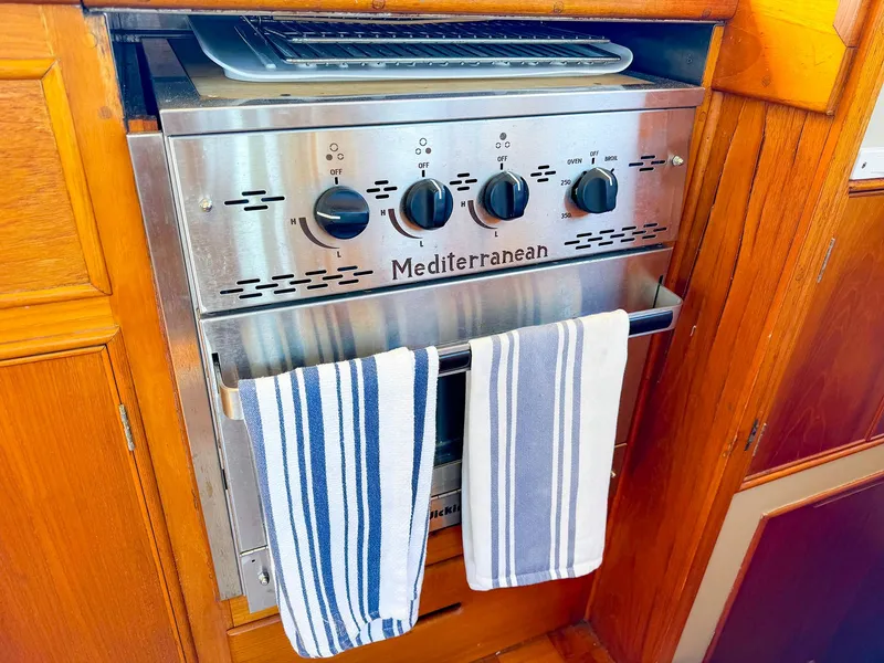 Slide: The Image of Mediterranean stove with striped towels in 1988 Grand Banks 42 Classic yacht kitchen. - 20