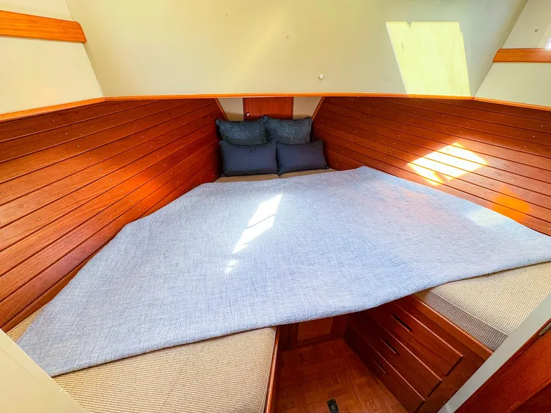 Slide: The Image of Cozy cabin interior of 1988 Grand Banks 42 Classic with wooden paneling and bedding. - 22