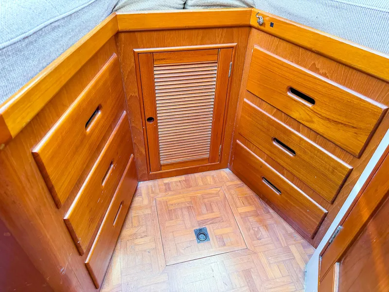 Slide: The Image of 1988 Grand Banks 42 Classic interior with wooden cabinetry and parquet flooring. - 24