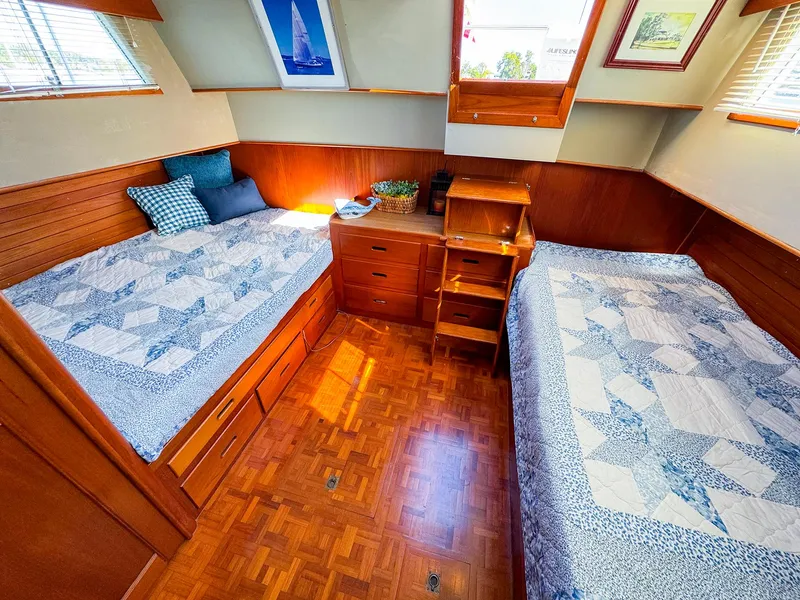 Slide: The Image of Cozy cabin interior of 1988 Grand Banks 42 Classic with twin beds and wooden furnishings. - 25