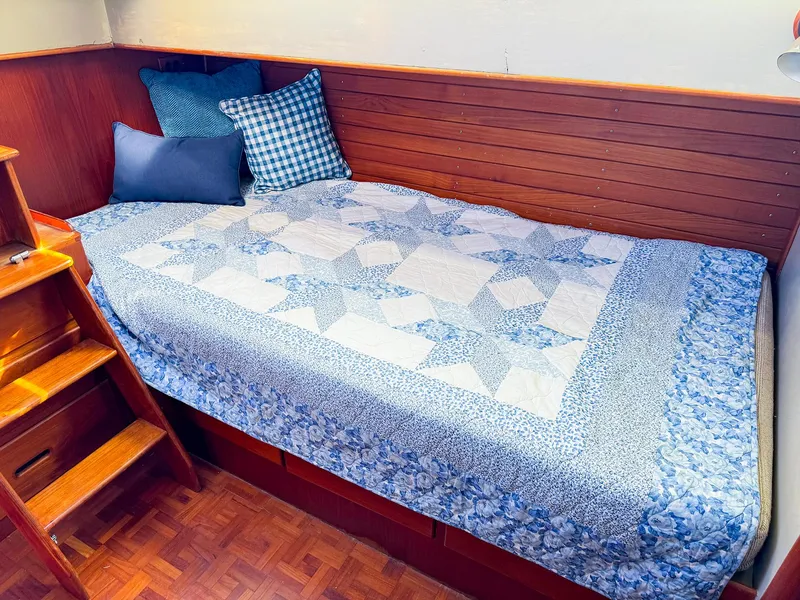 Slide: The Image of Cozy cabin bed with blue quilt on 1988 Grand Banks 42 Classic yacht. - 26