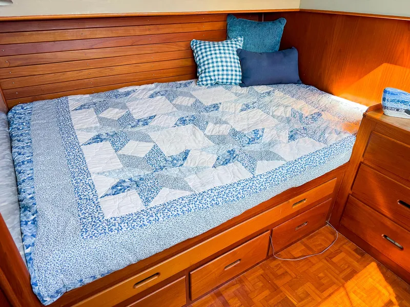 Slide: The Image of Cozy cabin bed with blue quilt on 1988 Grand Banks 42 Classic yacht. - 27
