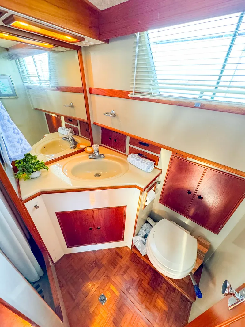 Slide: The Image of Elegant 1988 Grand Banks 42 Classic yacht bathroom with wood accents and modern fixtures. - 28