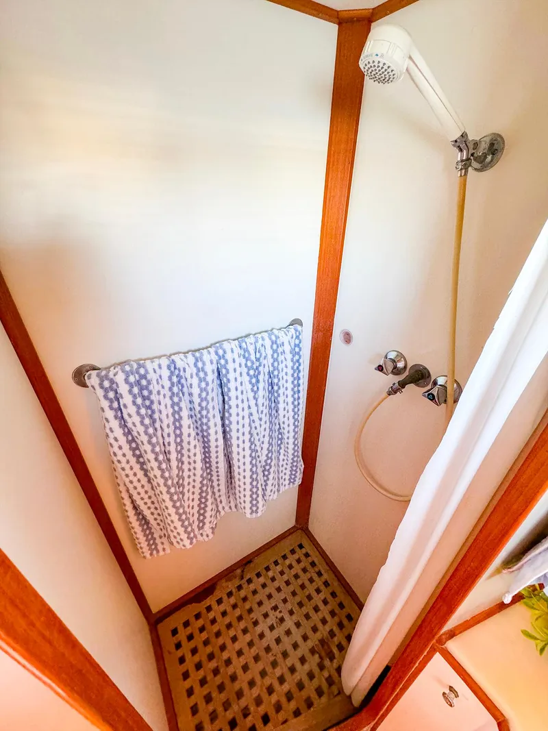 Slide: The Image of Shower area in 1988 Grand Banks 42 Classic yacht with wooden accents and towel rack. - 29