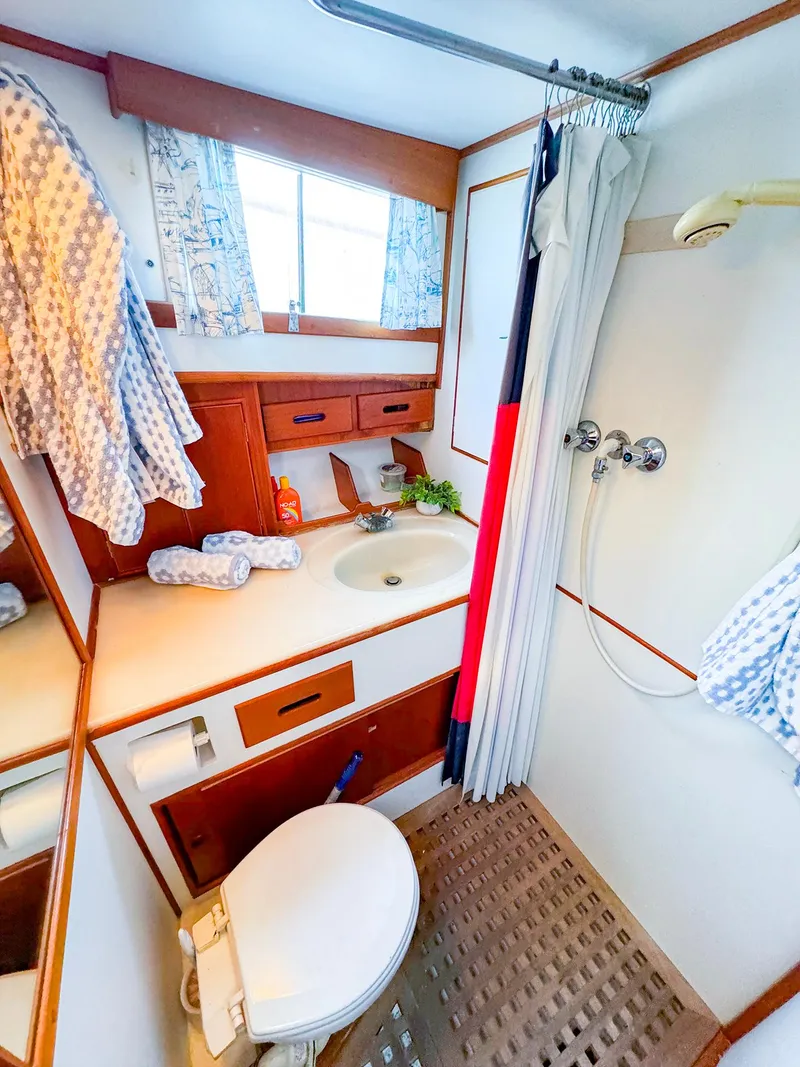 Slide: The Image of 1988 Grand Banks 42 Classic yacht bathroom with shower, sink, and toilet. - 31