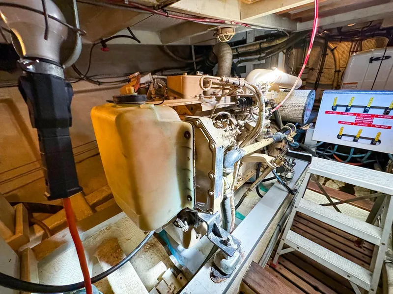 Slide: The Image of Engine room of 1988 Grand Banks 42 Classic yacht, showcasing mechanical components and wiring. - 34