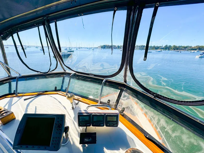 Slide: The Image of Interior view of 1988 Grand Banks 42 Classic yacht helm with ocean scenery. - 8