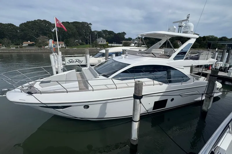 The Image of Azimut 50 Flybridge 2021 yacht docked at marina, featuring sleek design and modern amenities. - 0