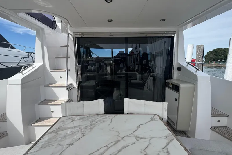 Slide: The Image of 2021 Azimut 50 Flybridge yacht with marble table and modern interior design. - 10