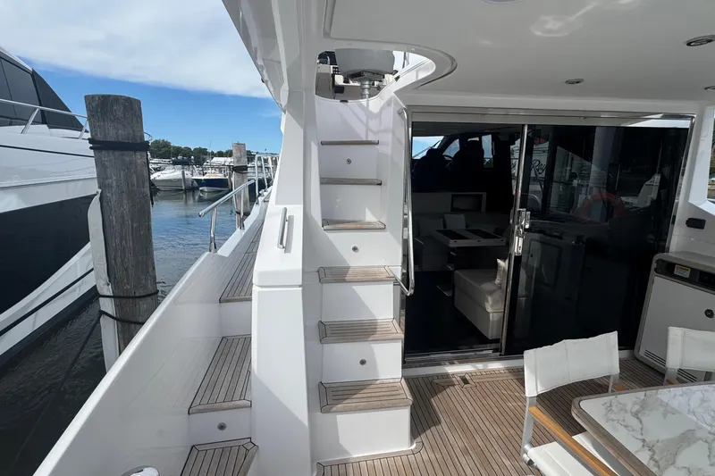 Slide: The Image of Azimut 50 Flybridge 2021 yacht interior with stairs and seating area. - 15
